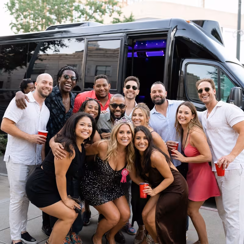Group boarding a white charter bus for Birthday Transportation transportation in Shreveport