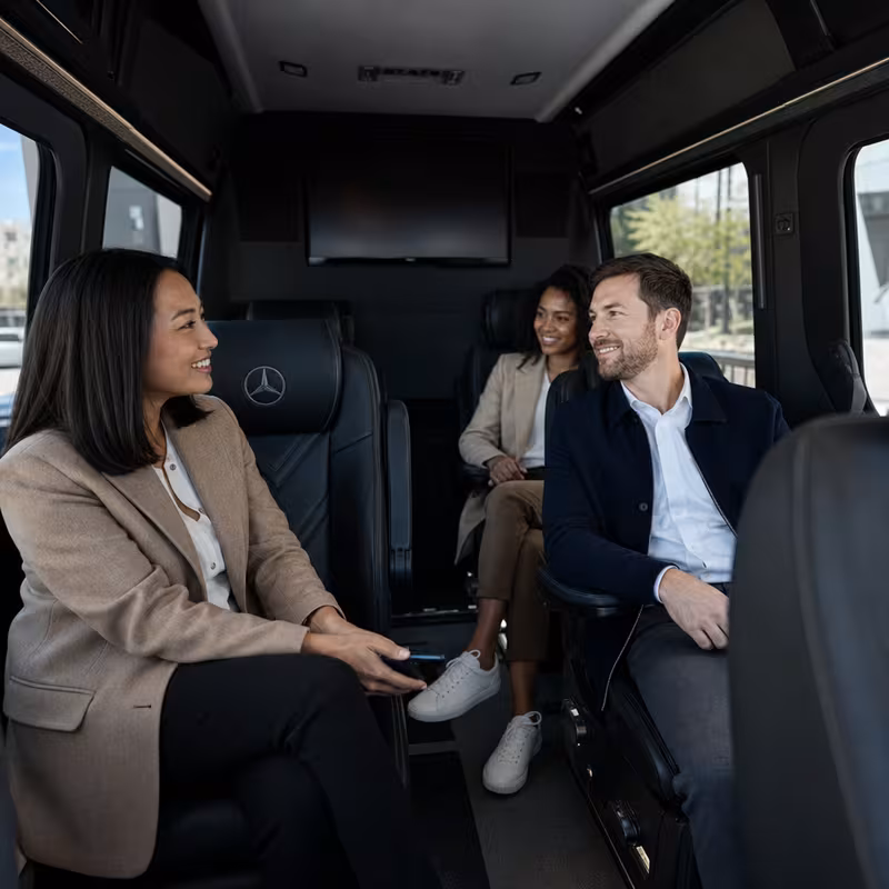 Group boarding a white charter bus for Corporate Transportation transportation in Shreveport