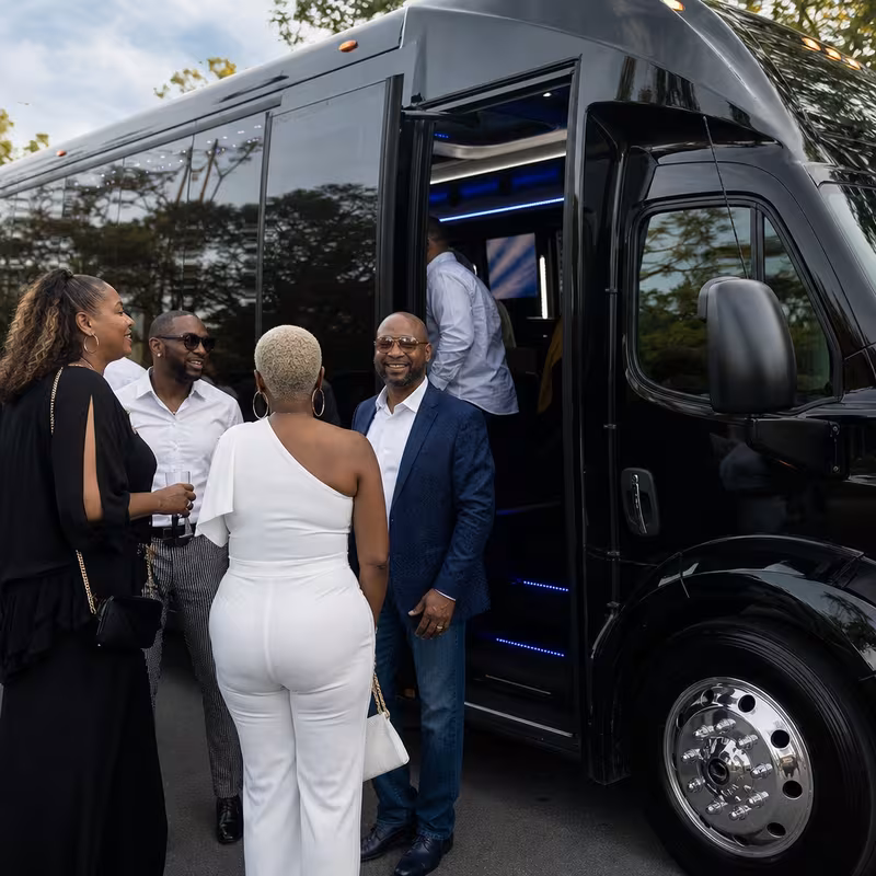 Passengers loading luggage while boarding an Shreveport group shuttle