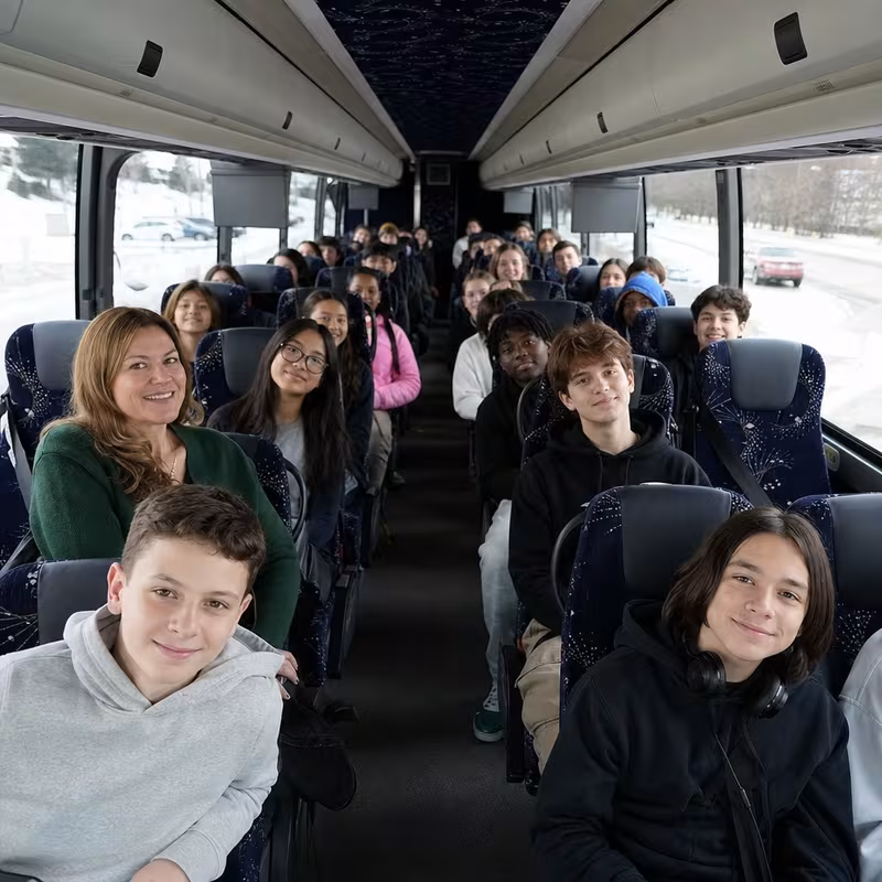 Group boarding a white charter bus for School Transportation transportation in Shreveport