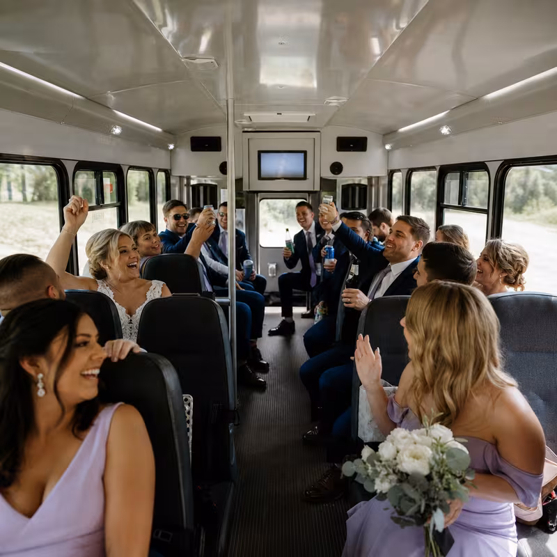 Group boarding a white charter bus for Wedding Transportation transportation in Shreveport