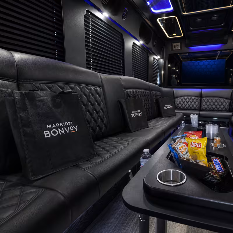Party bus interior with wraparound leather seating and LED lighting in Shreveport